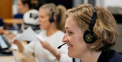 MSI UK call agent with headset smiling