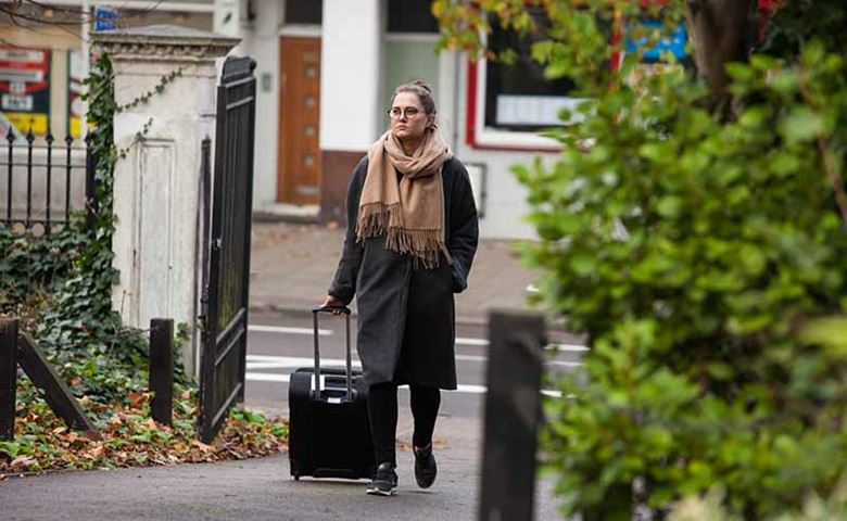 MSI UK abortion client walking holding luggage